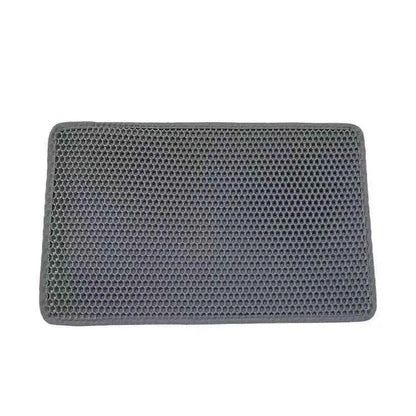 Cat stepping on a litter trapping mat